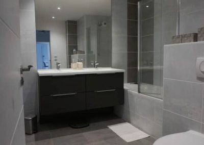 Salle de bain avec meuble double vasque et baignoire